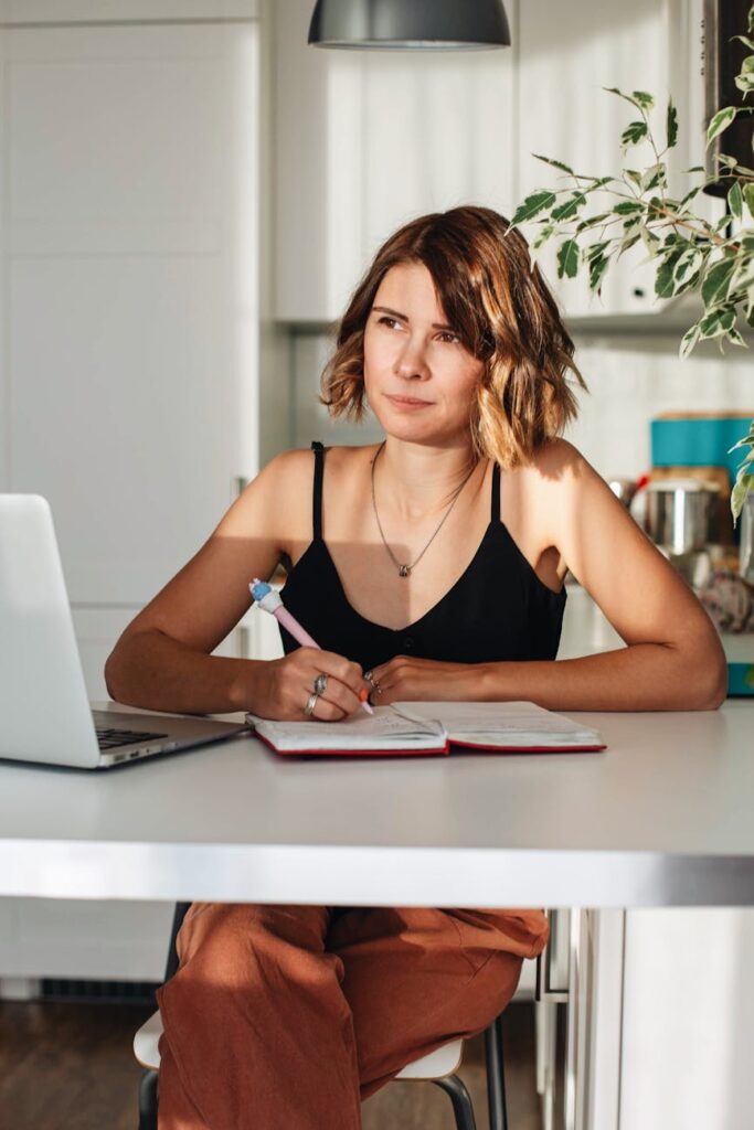 a businesswoman taking notes on her notebook